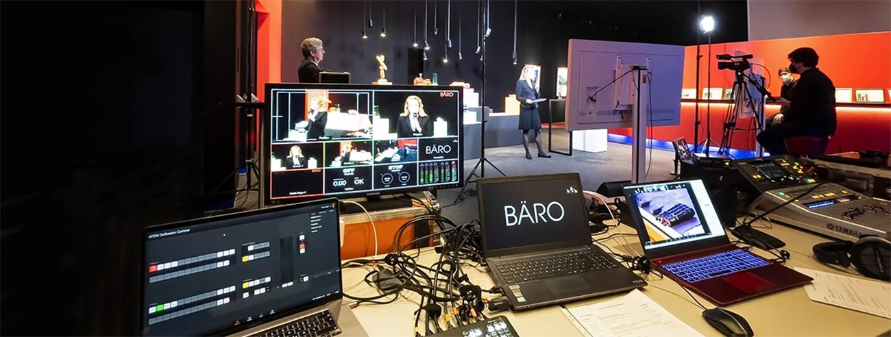 View into a studio with cameras and control room, from which a client's executive is streaming a broadcast to his employees.