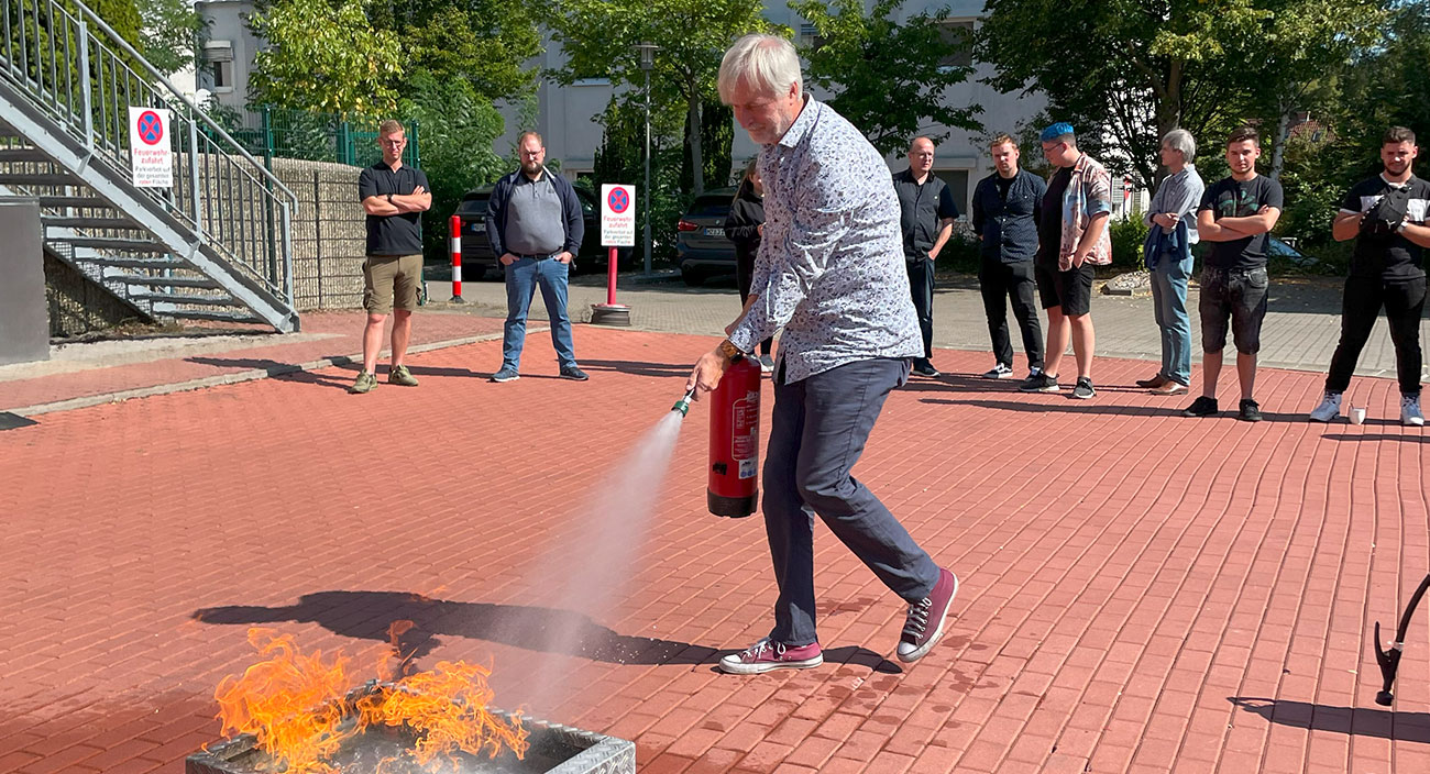 Jörg, one of our bosses, during the fire extinguisher exercise. No, the others are neither bored nor skeptical.
