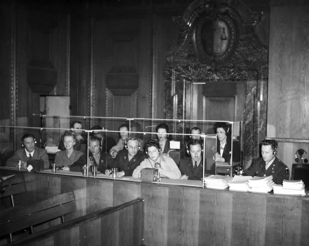 Historical black and white photograph with interpreters at the Nuremberg Trials